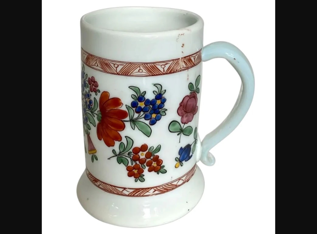 Bohemian Milch (Milk) Enameled Glass 1760s Ale Stein/Mug: Bohemian Milch (Milk) Enameled Glass Floral Ale Stein / Mug. An antique mug with hand painted with polychrome flowers on a white hand blown milk glass body. Width 5 Depth 3.75 Height 5.5 inches. Circa