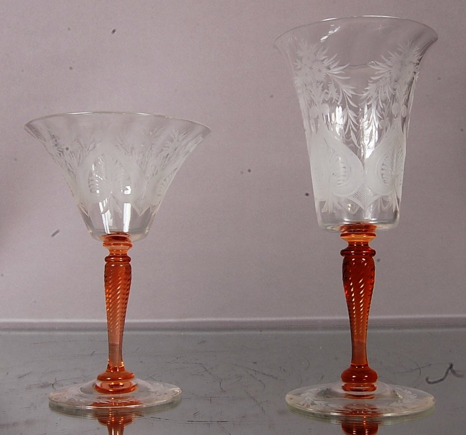 2 Stueben wine glasses: 1 red wine 8 1/2" t x 4" w. 1 white wine 6 1/2" t x 4 1/2" w. Signed on bottom Steuben. Ca. 1920. From the estate of Sallie P. Kimbrough.