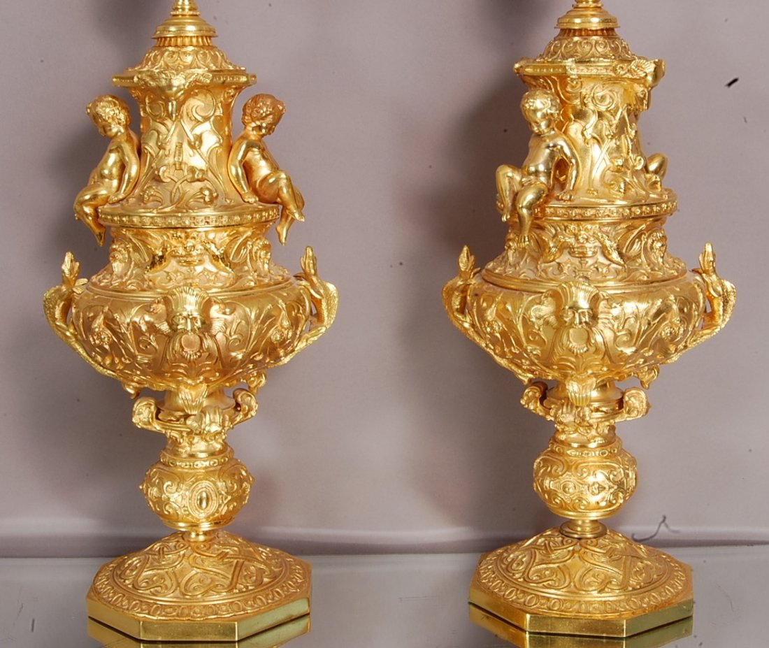 Pair of Italian Renaissance style Bronze lamps: With cherubs sitting on sides with gargoyles, birds & lizards. Electrified. 26" t x 9" d. Ca. 1920