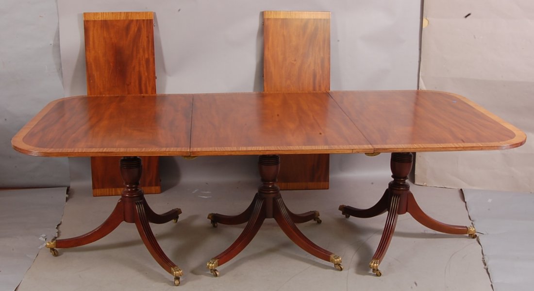 Triple Pedestal Banded Inlaid Table: Sheraton style, triple pedestal, banded inlay dining table. With 2 leaves and 3 sections. End sections are tilt tops. 48" wide x 11' long x 30" tall. Fully extended. England, Ca. 1900