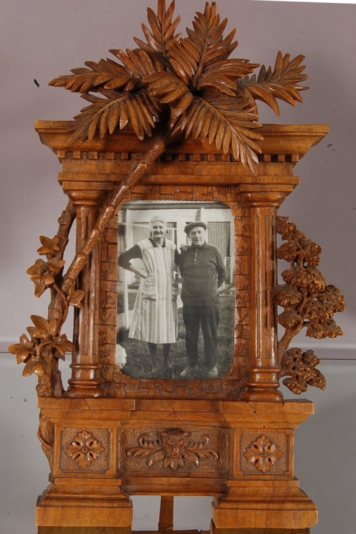 Black Forest style Walnut Frame: Detailed carving of trees and flowers. With lion bust carved in base. 20" t x 12" w. Ca. 1880