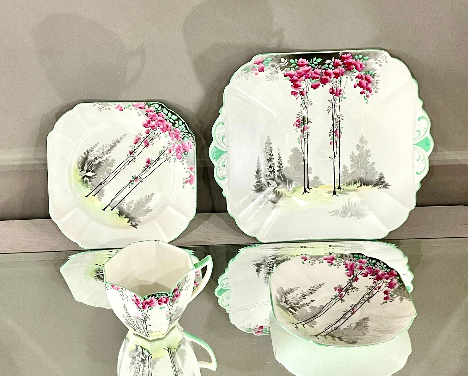 Shelley Four Piece Art Deco Tea Set: MARKS: signed Shelley DIMENSIONS: large plate 1"t x 9 1/4"-8", small plate 1/2"t x 6 4/1"-6", tea cup and creamer 3"t x 5"w. CIRCA: 1920.