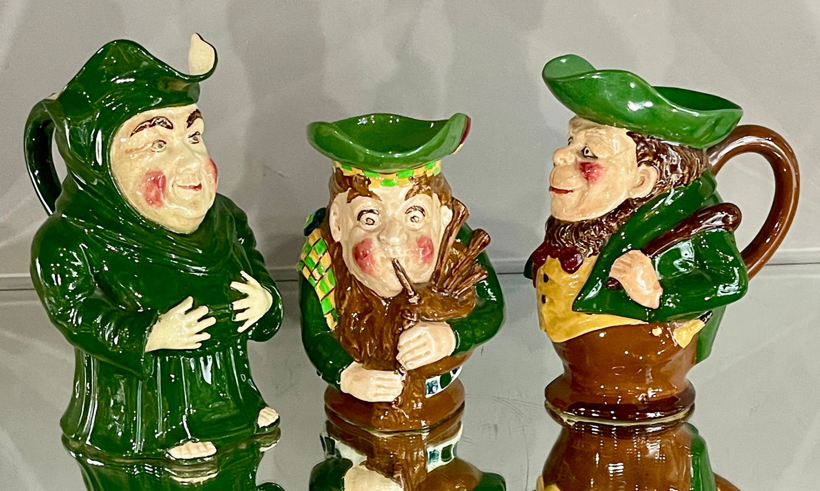 Three Foley "Intarsio" Hand Painted Jugs: Pattern # 346, 3458. MARKS: signed on bottom Wilemand & Co. DIMENSIONS: 8 3/4"t x 6"d, 7 1/2"t x 6"d x 5"w, 6 3/4"t x 6"d x 4 1/2"w. ORIGIN: England CIRCA: 1910.