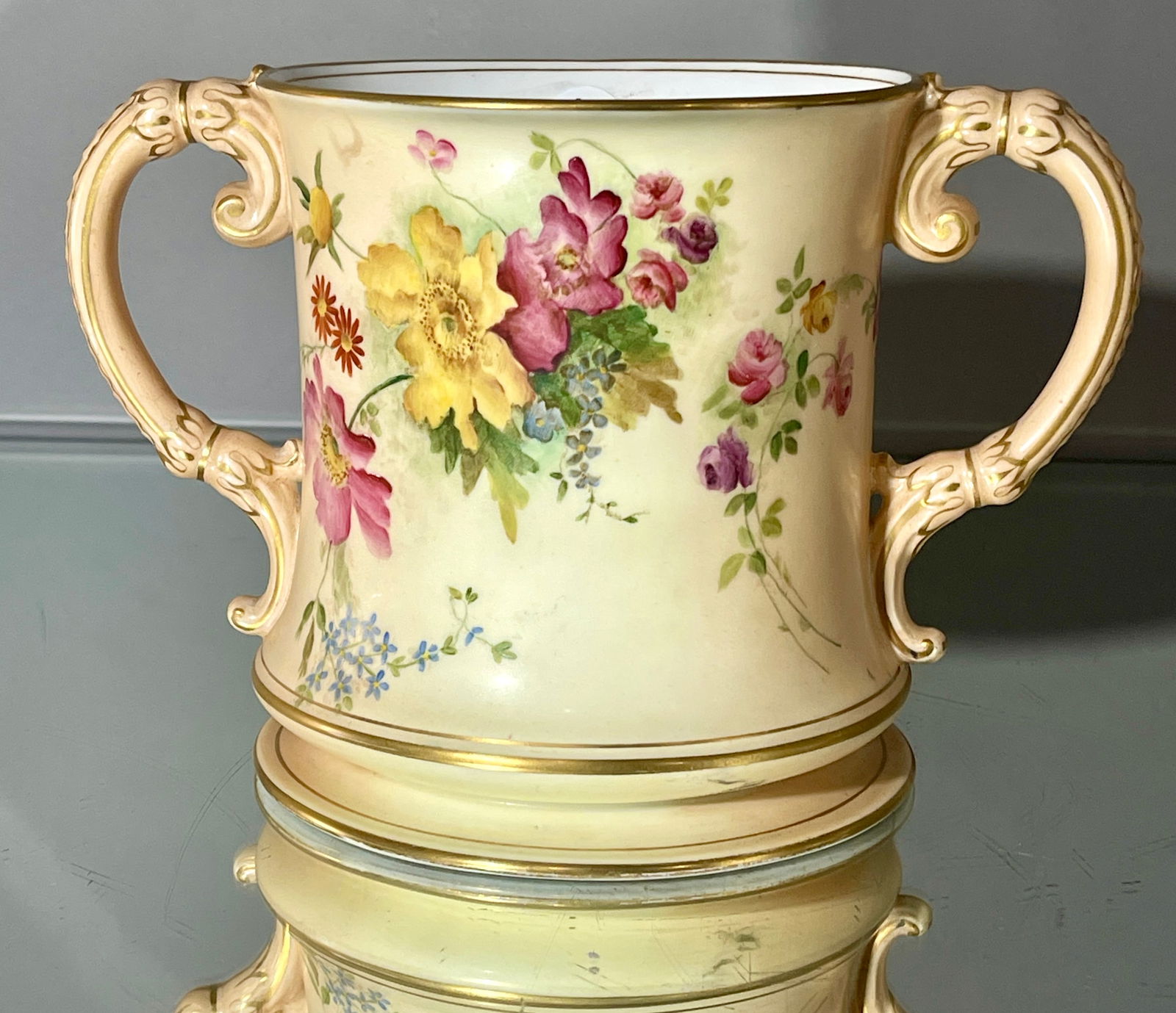 Large Royal Worcester Porcelain Blush Ivory Cup: Two-handles, floral decorated with gold trim MARKS: marked on bottom Royal Worcester DIMENSIONS: 6"t x 9 1/2""w ORIGIN: England CIRCA: 1900.