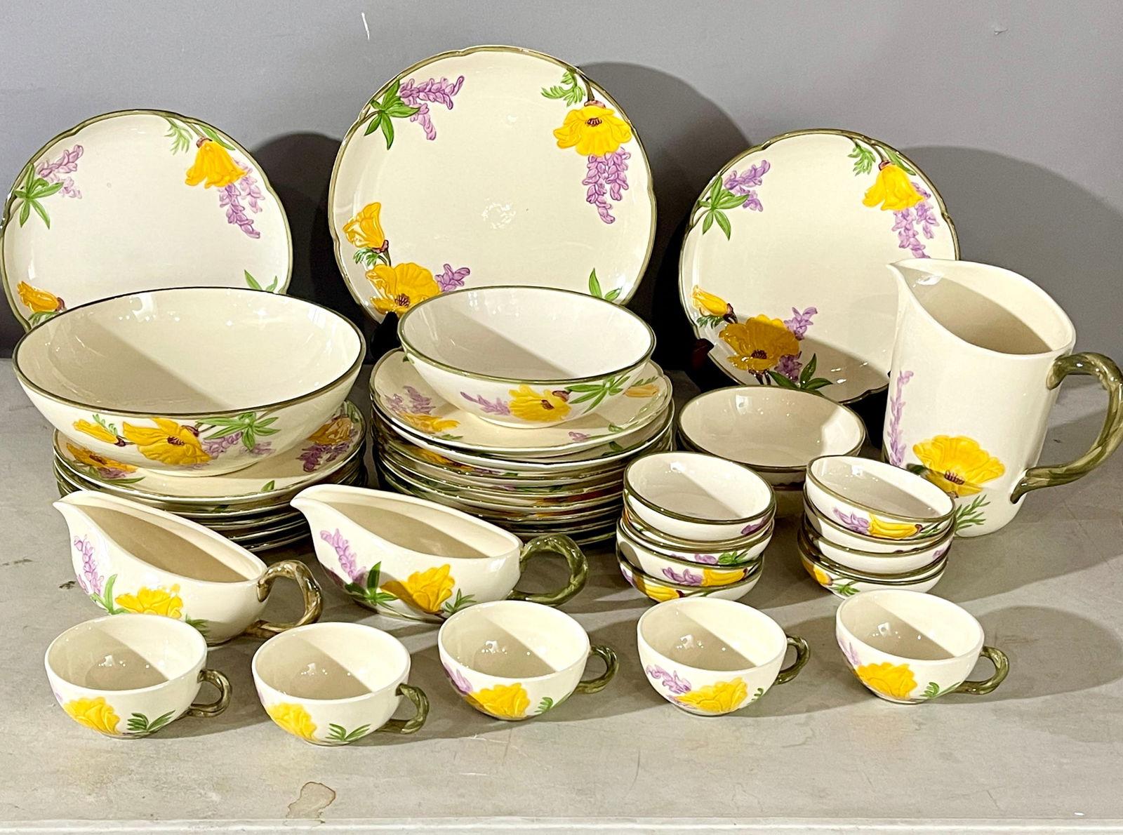Vintage Franciscan California Dinner Set: Vintage Fransican Californial Poppy (Yellow & Purple) partial dinner set, 38 pieces. DIMENSIONS: large plates 12" plates 10" pitcher 8" ORIGIN: USA CIRCA: 1950.