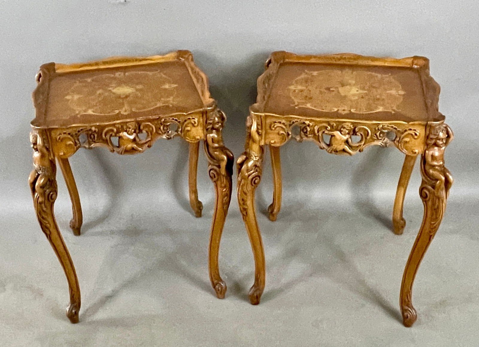 Vintage Italian Marquetry Mahogany Side Table: Floral inlaid top, carved skirt with cherubs on all sides and legs. DIMENSIONS: 28 1/2"t x 24"w ORIGIN: Italy CIRCA: 1920.