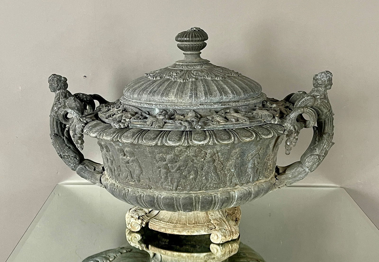 Lidded 19th Century Wine Cooler: Two handles, green patina on grape and leaf design around the top, spelter base. CONDITION: some losses DIMENSIONS: 17"t x 20"d x 24"w CIRCA: 1890.