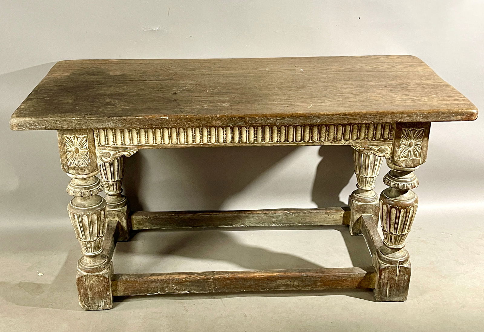 19th C English OAk Jacobean Style Table: Rectangular top, spoon carved skirt, fluted legs with stretched base. DIMENSIONS: 30"t x 28"d xx 58"w ORIGIN: England CIRCA: 1860.