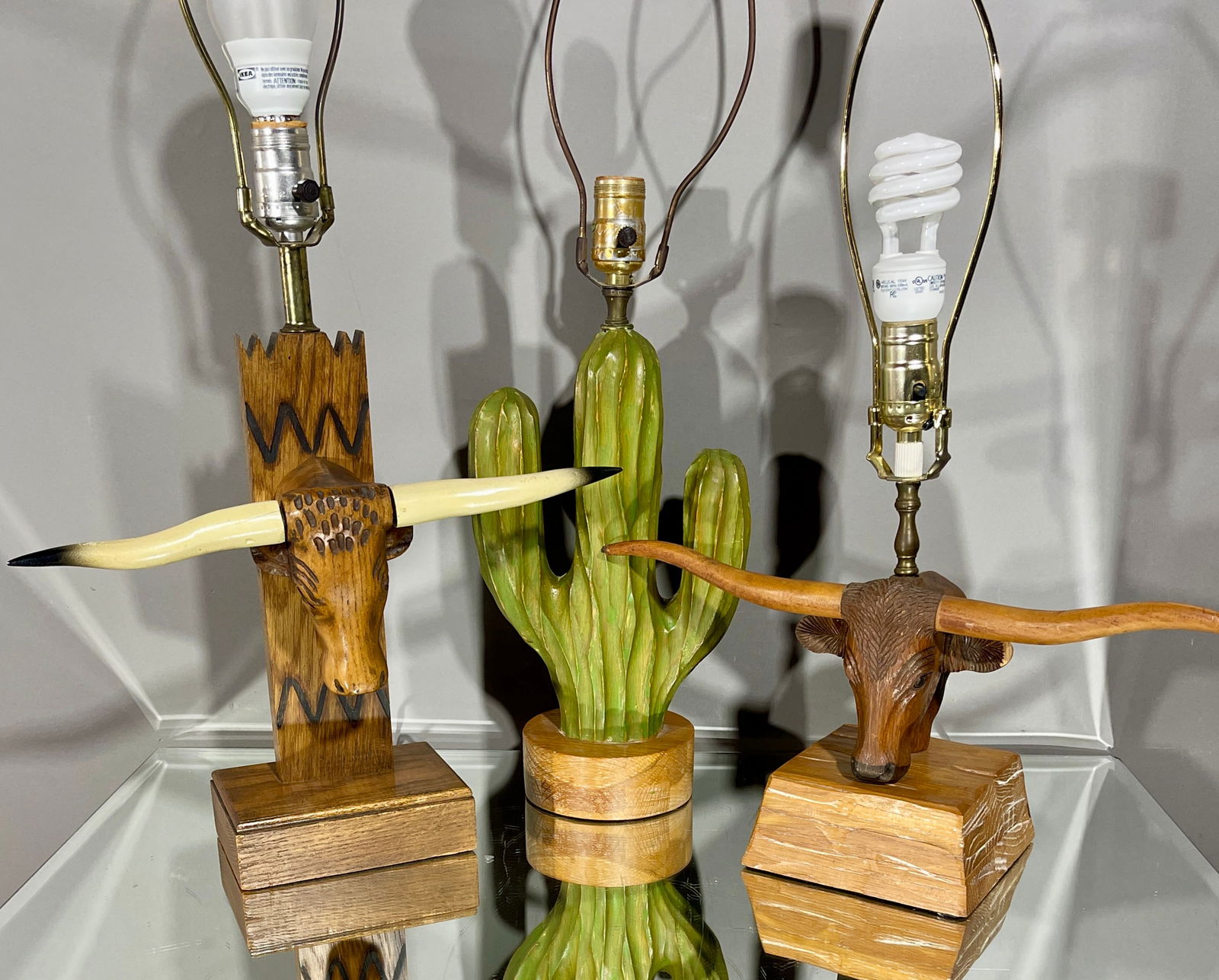 3 Vintage Brandt Ranch Oak Pieces: 2 longhorn steers, 1 cactus rug (22" x 17"). DIMENSIONS: 1) 17 1/2"t x 4"d x 6"w 2) 25" x 6" CIRCA: 1960.