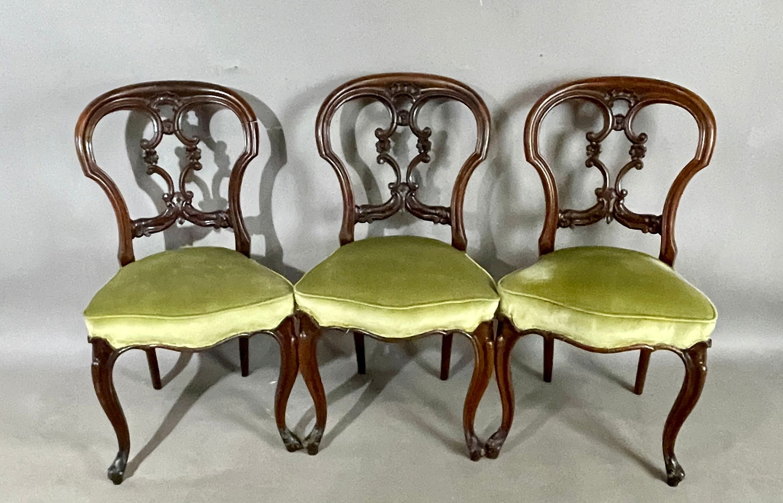 3 Victorian Walnut Balloon Back Chairs: With upholstered seats. DIMENSIONS: 45"t x 16"d x 19"w ORIGIN: England CIRCA: 1880.
