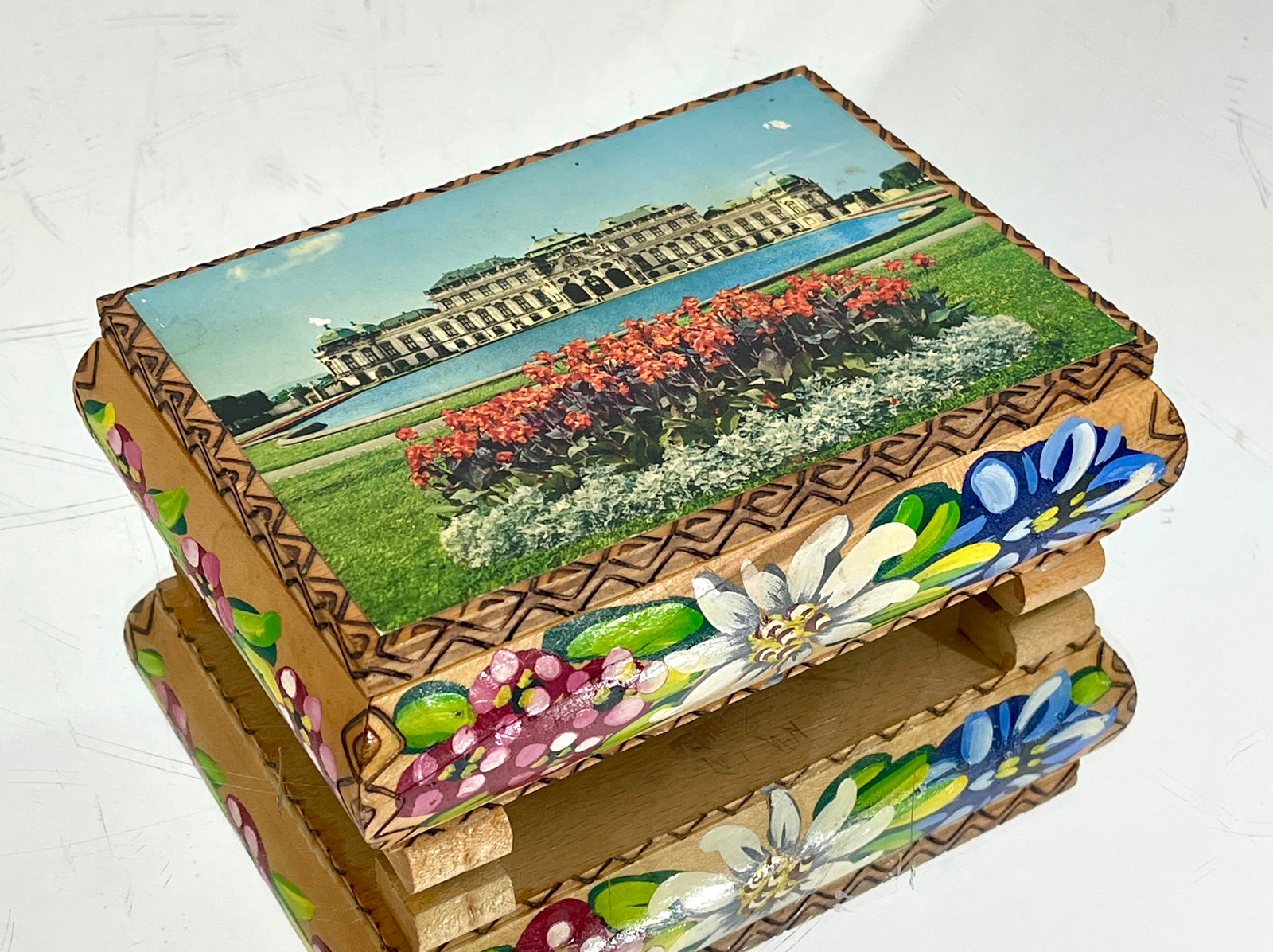 Wien Reuge Decorated Wooden Jewelry Box: With Swiss movement CONDITION: working condition DIMENSIONS: 2 1/4"t x 5"d x 6 1/2"w ORIGIN: Switzerland CIRCA: 1920.