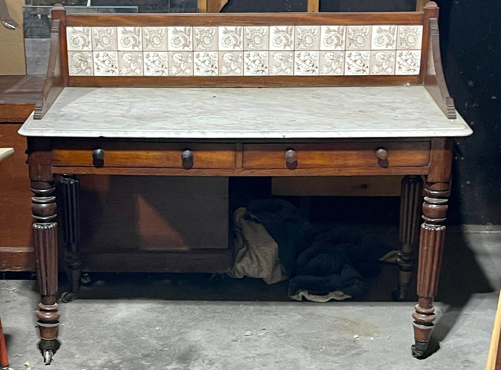 English Mt. Wash Stand: Tile back with 2 drawers on turned legs. DIMENSIONS: 37"t x 22"d x 47"w ORIGIN: England CIRCA: 1880