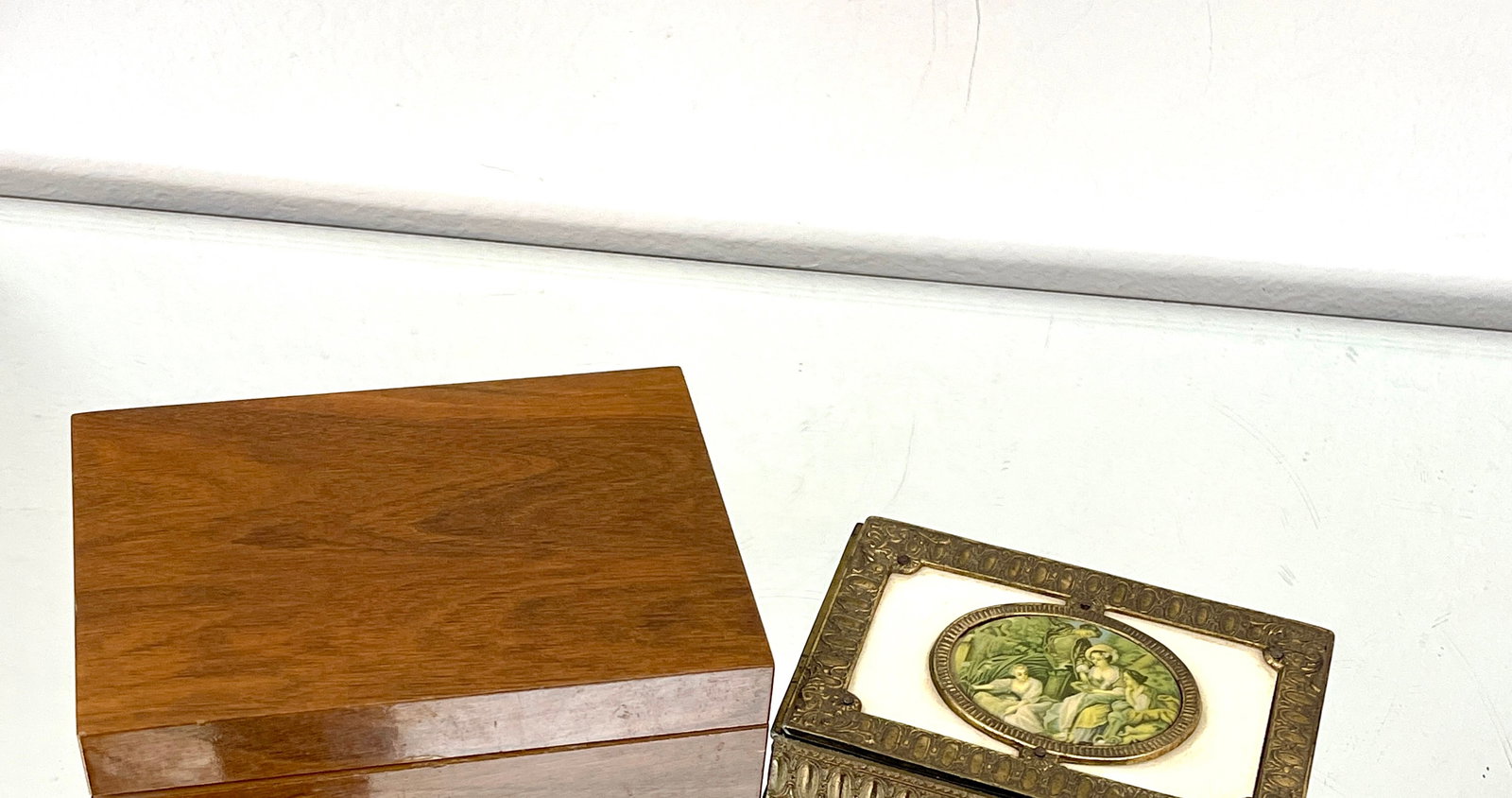 Two Swiss Jewelry Boxes: 1) walnut 3" x 5" x 7" 2) brass (missing foot) 2"t x 3 1/2"d x 5"w CONDITION: both working CIRCA: 1920
