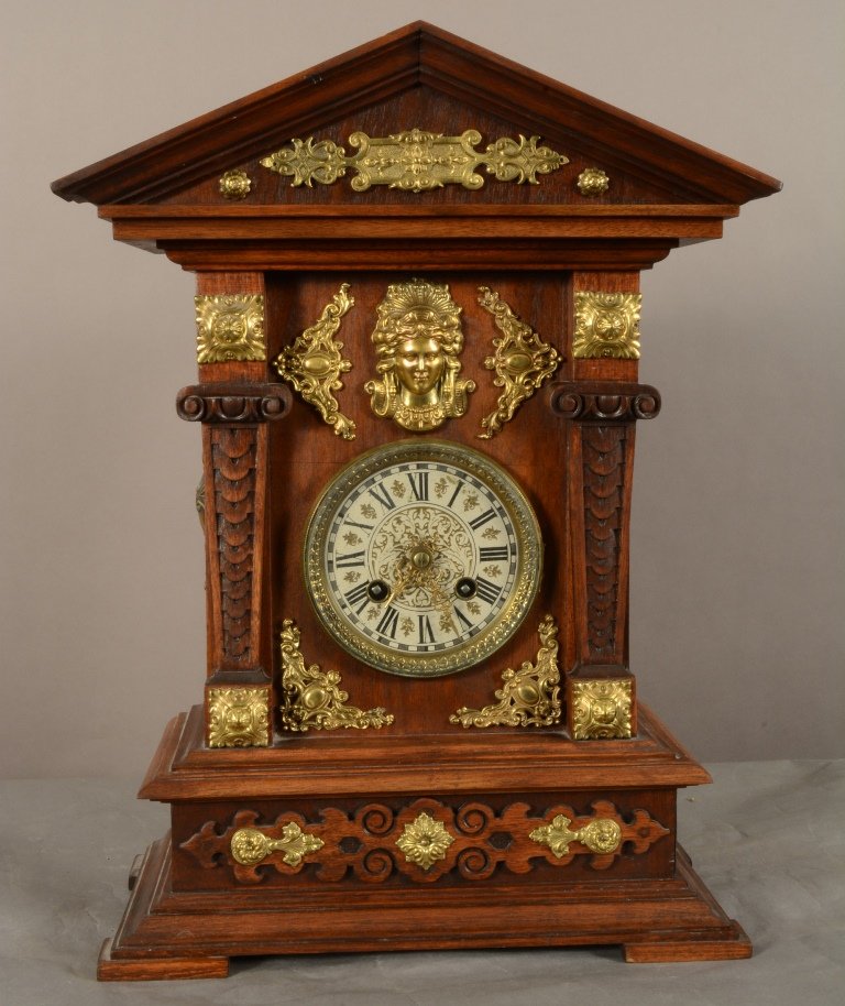 German Walnut wall clock: With fance brass decorations. Time & strike. Missing back panel. 19" t x 13" w. Ca. 1880