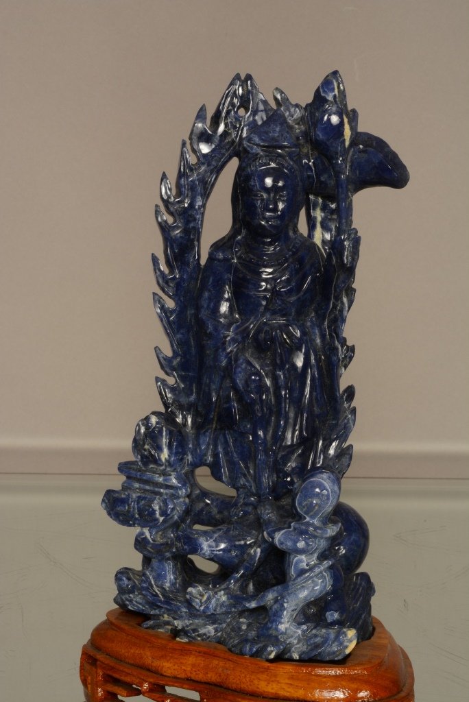 Chinese sodalite carvint of Quan Yin & attendant: On wood base. 8 1/2" t. 20th Century.