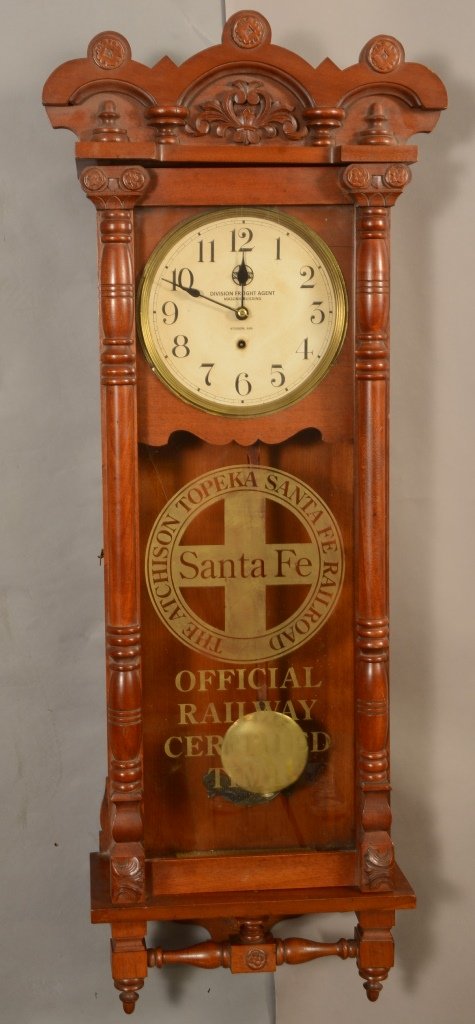 New Haven Rail Road Station lock: Stante Fe Railroad in mahogany case. 8 Day movement. Original paper label on inside. 49" t x 16" w. Ca. 1890