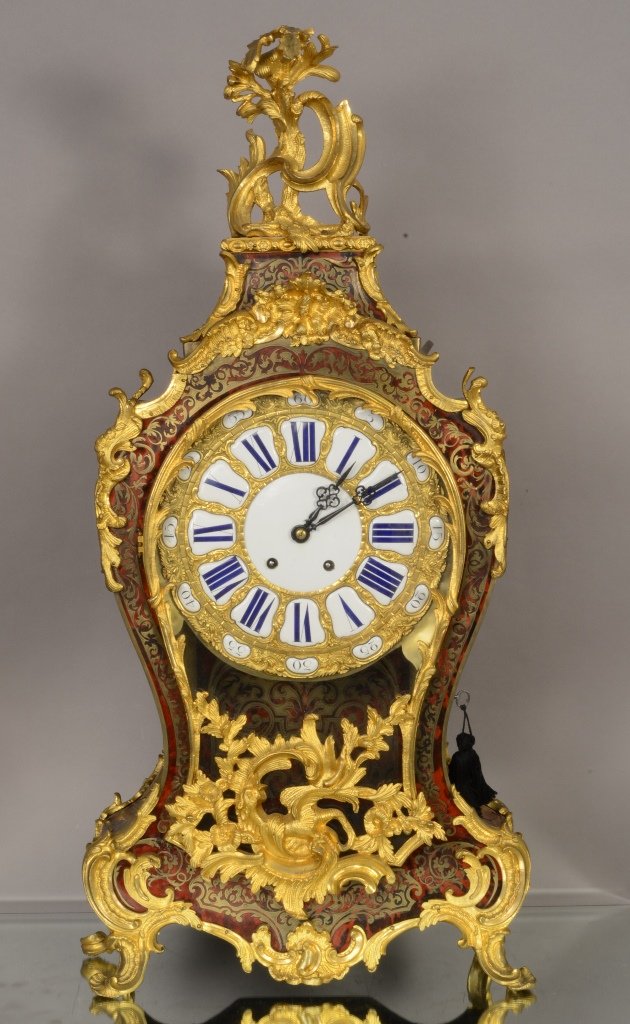 French Louis XV Boulle Cartel Clock: Bronze Boulle & inlaid brass decorations with shelf. 10" porcelain & bronze dial. Time & 2 bell strike. Works signed Pons Clock is 34"t x 16" w. With the shelf it is 48" t. Excellent condition. Ca. 18