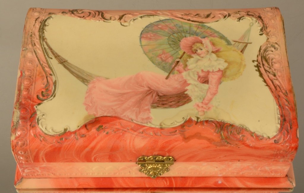 Victorian Dresser Box: This Victorian dresser box features a lady on a swing with pink floral design on celluloid. Circa 1900. 3" T x 8" W x 6" D