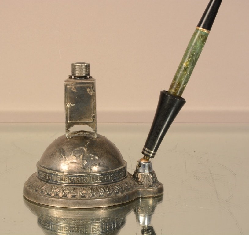 General Electric Refrigerator ink pen holder: Silver plate, refrigerator sitting on a globe. 9" t x 4" d. Ca. 1920