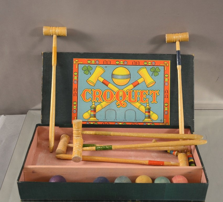 Child's Wooden Croquet Set: With mallets, balls, and pin. In original box. Circa 1900. 18" l 9" w.