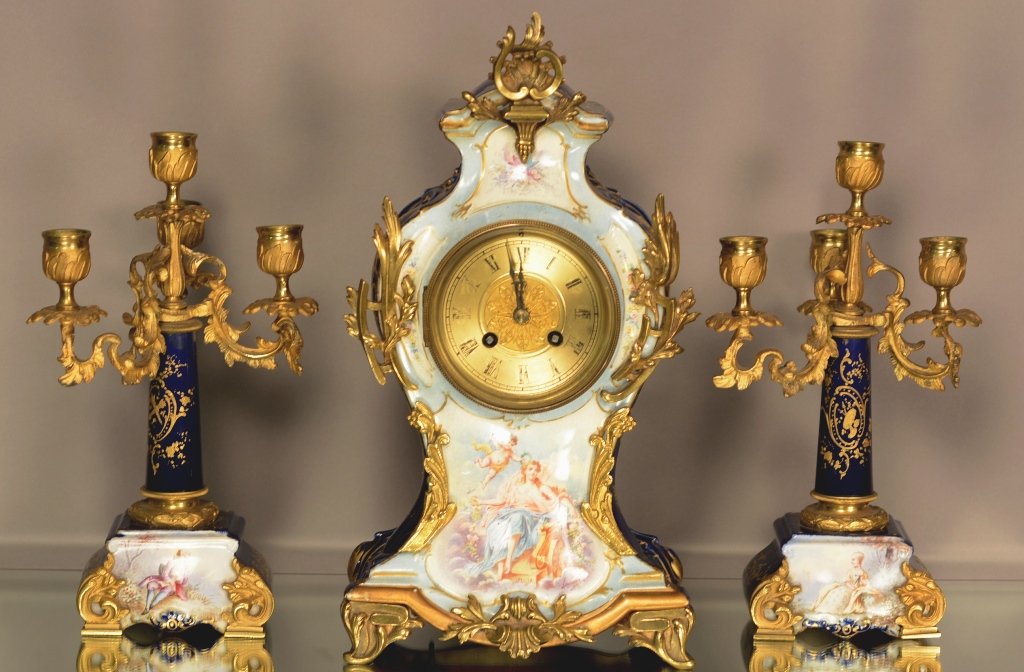 French Louis XV Style 3 Piece Clock Set: French Louis XV Style, bronze & porcelain, 3 piece clock set. Cobalt blue Serves style. Hand painted. Romantic scene. Artist signed case. Bronze mounts. Time & strike. Japy Frères movement. ca. 1890.