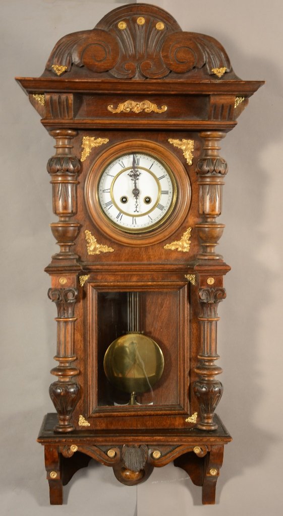 German R.A. Regulator Wall Clock: German R.A. Regulator wall clock. Fancy walnut case with four columns. Brass trim decorated case. Time and strike. Porcelain dial. ca. 1895. 34" tall