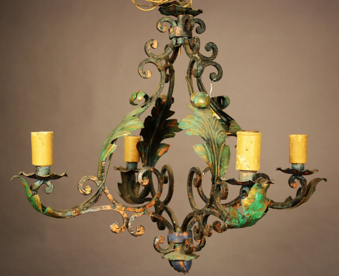 French Provincial Style Wrought Iron Light Fixture: French Provincial style, four arm, wrought iron fixture with leaf design on arm. ca. 1910. 21" t x 27" w