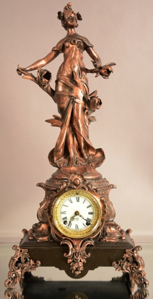 Ansonia "Olympia" Figural Mantel Clock: Ansonia "Olympia" figural mantel clock. Spelter statue of woman holding flowers. Porcelain dial. Time and Strike. Works Signed Ansonia.