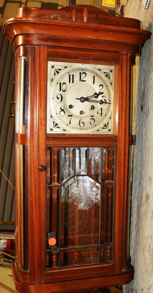 German Art Deco Style Westminster Chime Wall Clock: German art deco style, Westminster chime wall clock. Mahogany case with curved and beveled glass door. Triple wind. ca. 1920. 33" t x 14" w