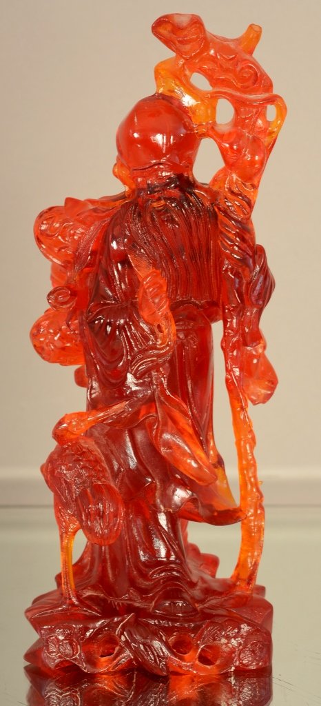 Chinese cherry amber statue of man on stand. (1 of 1)