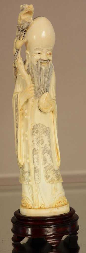 Antique Chinese statue of a religious figure. (1 of 3)