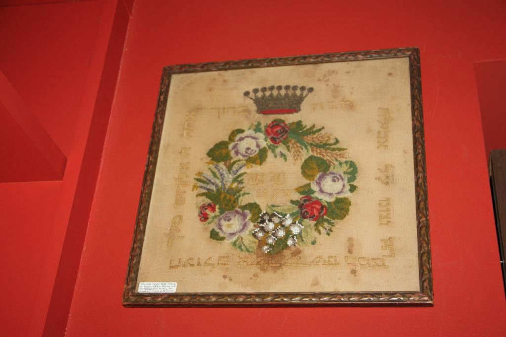 1872 Sampler Mazzah Blessing Joel Lieberman: A unique sampler from 1872 by a 12 year old girl. Blessing over the Mazzah after drinking the second cup of wine at Passover. Written on the back of the frame "To Joel Lieberman- After my decease will