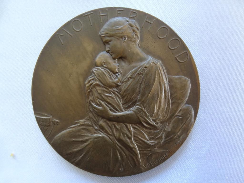 Medallion: 1911 Motherhood Medal. Bronze: 1911 Motherhood Medal. Bronze, 70mm. By Victor B. Brenner. Smedley- 87, Alexander COF 4. About Uncirculated. Obv. Mother holding infant. Rev. Putto with trumpet on field blank for engraving. This was 