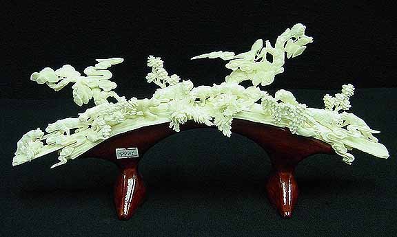 Bone Panthers Bridge: This bone carving is made of elephant bones. 10 panthers are carved on a jungle. All hand carved with lots of details. Size: L:15", W:5", H:7" (9905)