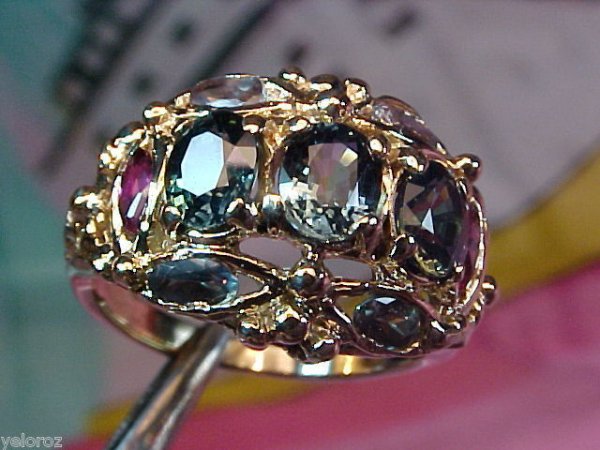 14K Yellow Gold Alexandrite, Ruby & Sapphire Ring: RAREST STONE IN THE WORLD GEM TYPE SAPPHIRE ACCENT GEM ALEXANDRITE & RUBY Weight twt 1.37ct Weight twt .37ct & twt .17ct Shape Oval Facet Clarity VVS Clean