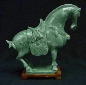 Jade Saddled Tang Horse: This horse is made from one piece solid Taiwan jade. It appears light green with some area dark green. It comes with a wooden base. Size: L: 9", W: 3", H: 8" (LH8)
