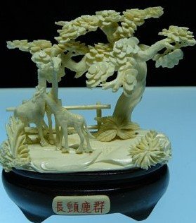 BONE 3 GIRAFFS JUNGLE: 9812B4 This beautiful art work is all hand carved from natural elephant bone. It comes with a rosewood stand Size: L: 5", W: 3", H: 5".