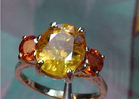 Rare Color Change Solitaire SAPPHIRE 14kt Ring: Solitaire SAPPHIRE Oval Facet 3.63ct & 9.7X8.2X6.0MM & Very Deep Cut which always enhances color in a gemstone, Clarity VVS2, Color Rare Color Change from Royal Golden to Mandarin Orange, Top Full Lus