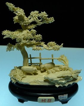 BONE PIGS JUNGLE: 9812A10 This beautiful art work is all hand carved from natural elephant bone. It comes with a rosewood stand Size: L: 7", W: 4", H: 8".