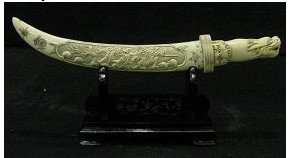29T: 14" ANTIQUE BONE SWORD SET: F2016 This sword set is made of Elephant Bone. It has been specially stained and it looks like ANTIQUE. There is a dragon carved in the front. It sits on a rosewood stand. The sword blade is also made