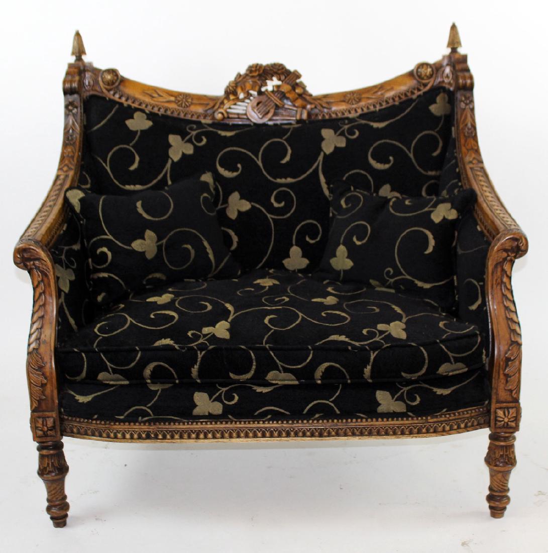 Louis XVI style carved mahogany settee: Louis XVI style carved mahogany settee with black and gold floral upholstery and carved attributes of the arts focal.40"h x 42"w