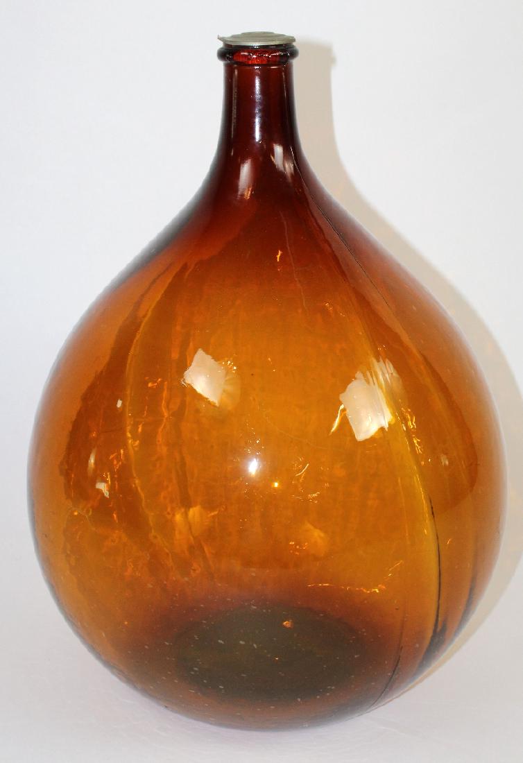 French amber glass demi-john wine bottle: French amber glass demi-john wine bottle. 21 1/2"h x 13 1/2"w