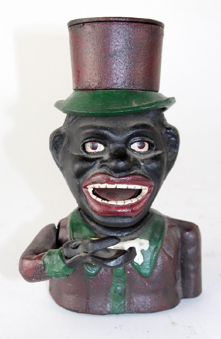 Painted cast iron "Jolly Negro" bank: Painted cast iron "Jolly Negro" bank. 8 1/2"h x 5 1/2"w
