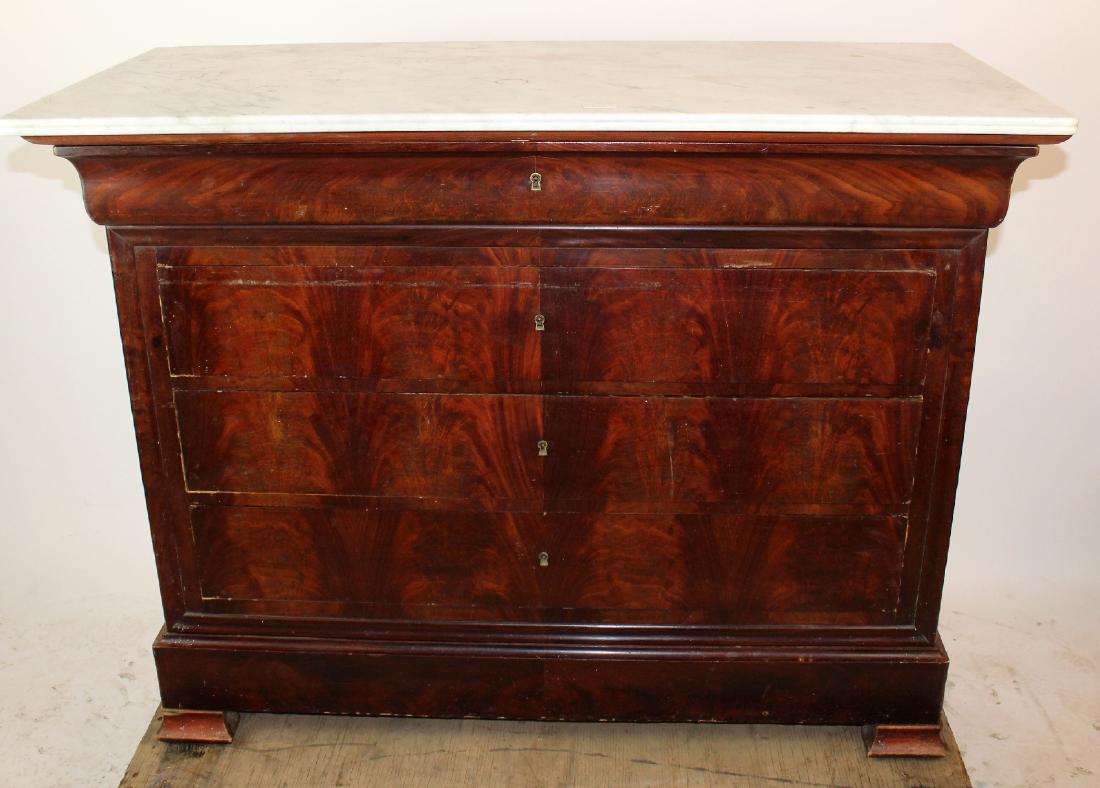 French Louis Philippe commode: French Louis Philippe commode in flame mahogany with mabrle top. 19th century. 38"h x 49"w x 22"d