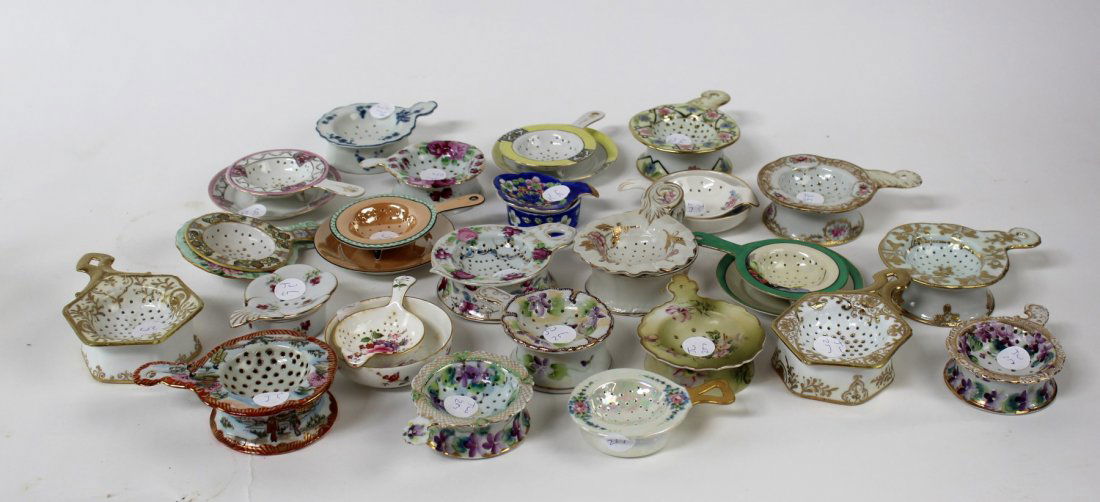 Collection of porcelain tea strainers and saucers (1 of 4)