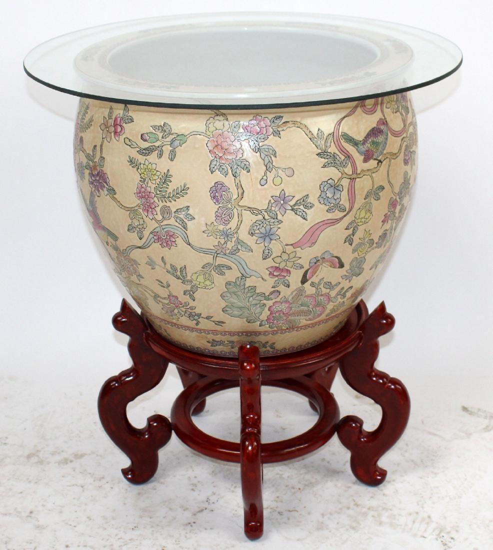 Chinese porcelain fish bowl on wooden stand: Chinese porcelain fish bowl on wooden stand with removalable glass top to make it into a side table. 27"h x 24" dia on the glass.