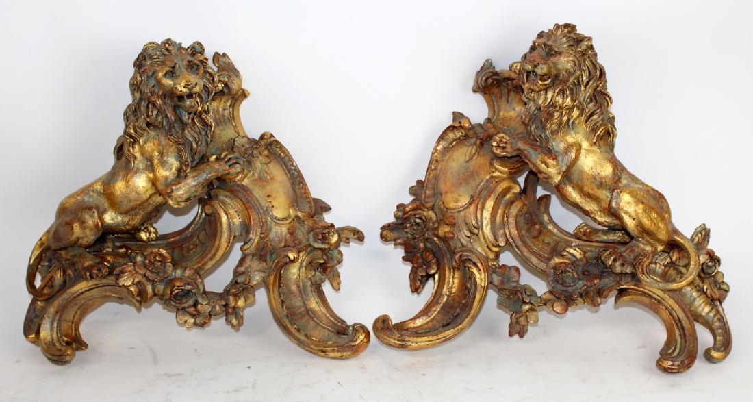 Pair of cast gilt Lion brackets: Pair of cast gilt Lion brackets with floral garland. 13"h x 15"w