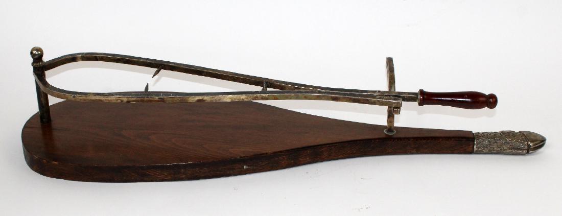 Italian ham carving stand: Italian ham carving stand with silverplate hoof form handle. 6"h x 30 1/2"l x 9"w