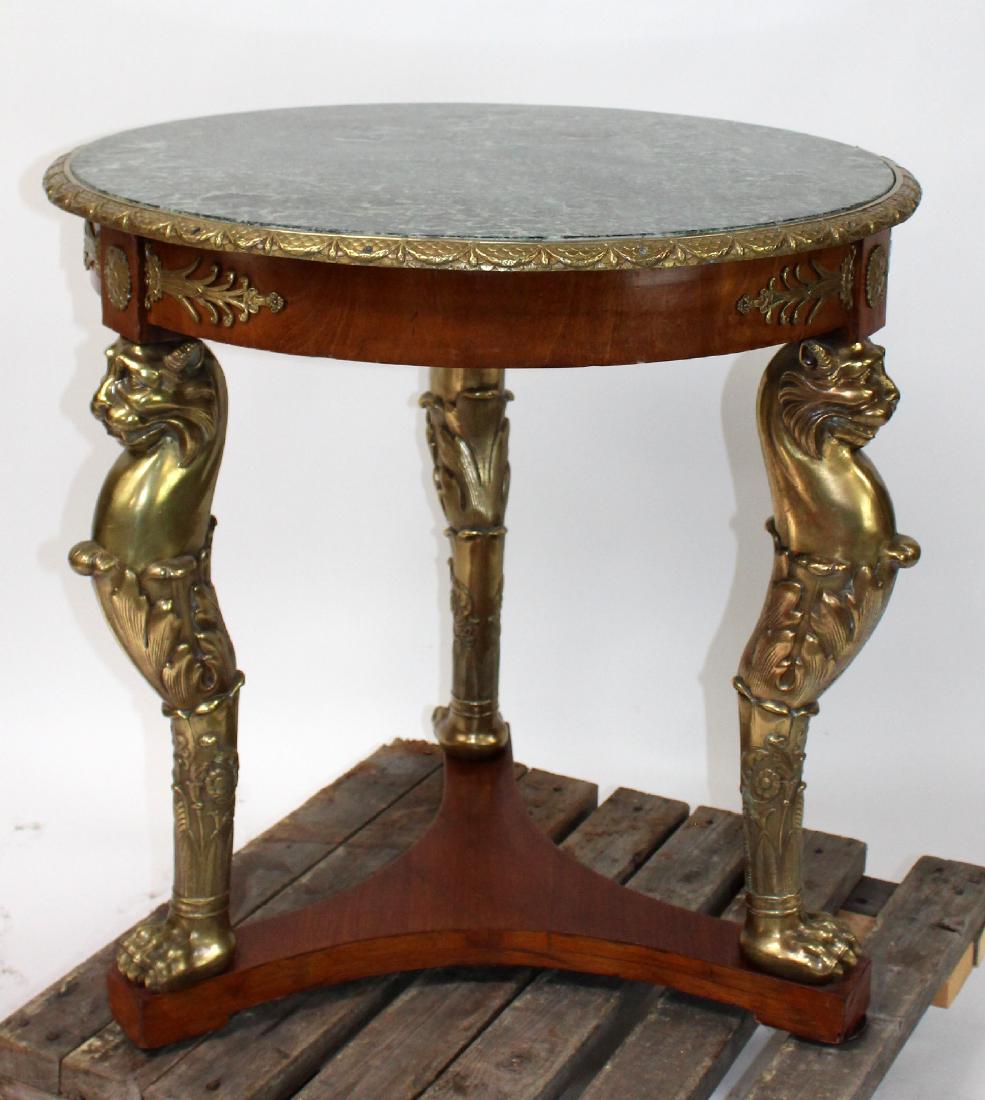 French Louis XVI bronze mount gueridon: French Louis XVI bronze mount gueridon with marble top and gryphon supports. Early 20th century. 31"h x 31 1/2" dia