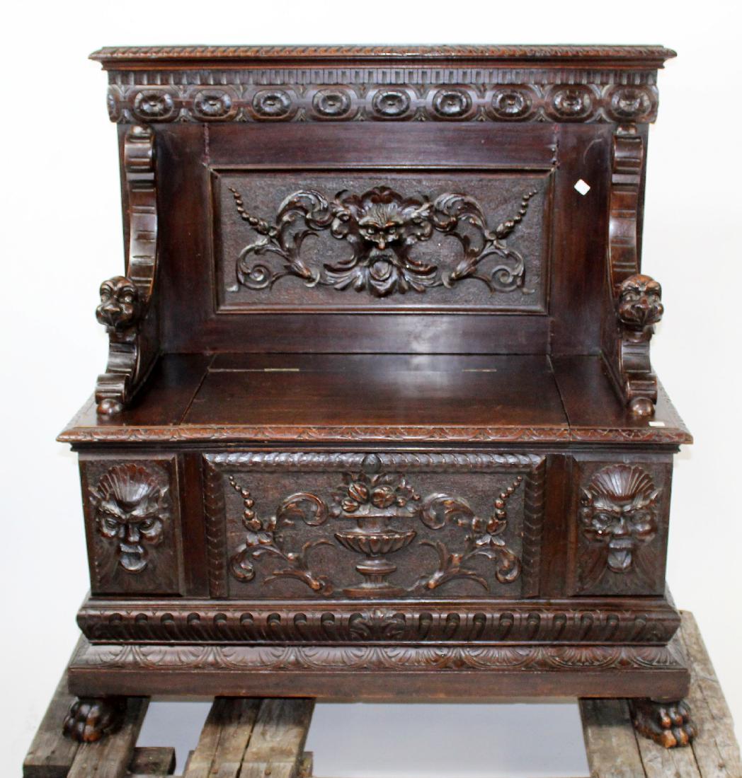 Italian Renaissance carved hallbench: Italian Renaissance carved hallbench with Northwind mask and fruited urn. Seat lifts to reveal storage area. Late 19th century. 46"h x 45"w x 21 1/2"d